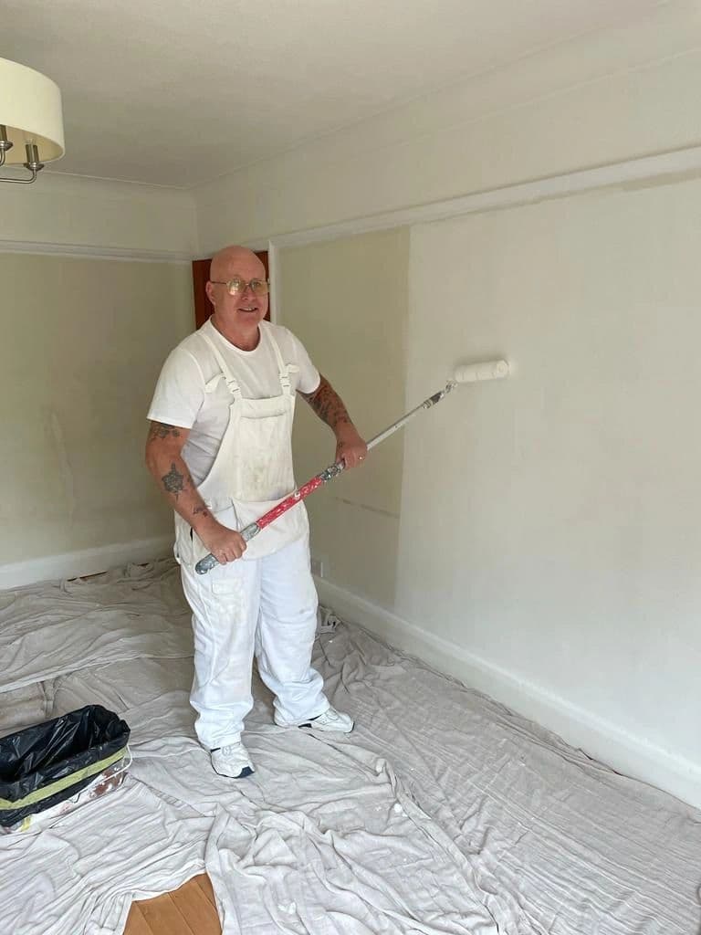 Mick Fry painting an interior room